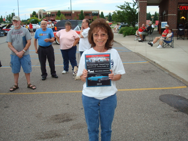 Sue Oxley smiles with her Best Original/Restored Cruiser award.